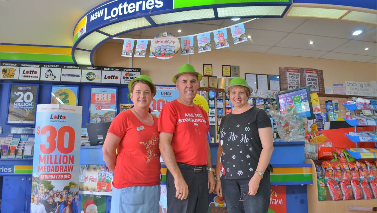 GRINNERS: Melanie Mitchell, Peter Searl, and Maria Searl from Searls Newsagency are thrilled the winner went to a Griffith resident. Picture: Kenji Sato