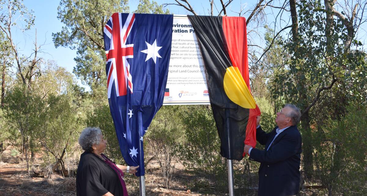 LAUNCH: Aunty Gloria Goolagong proudly unveils the sign for the project alongside Griffith City Council mayor John Dal Broi. PHOTO: Kenji Sato