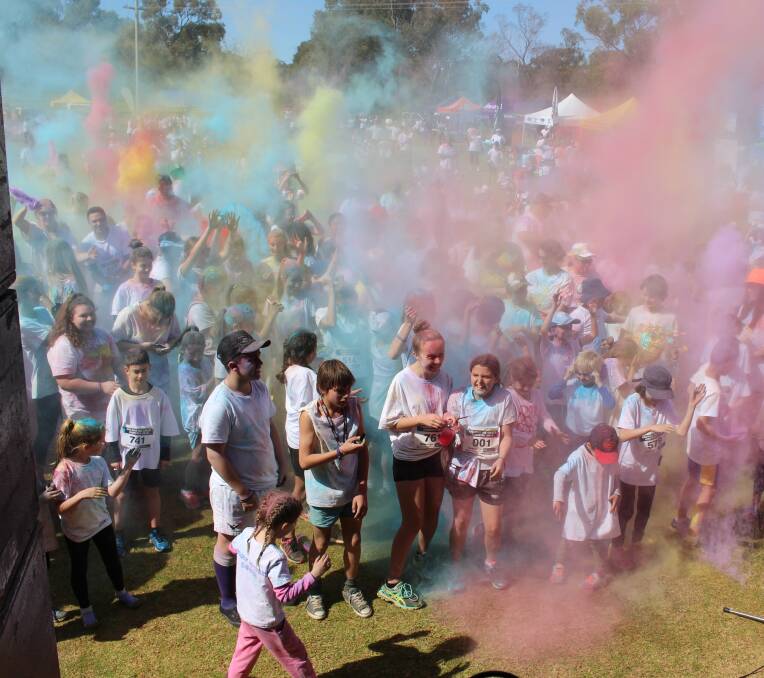EXPLOSION: Participants release their colour satchels into the air to celebrate.