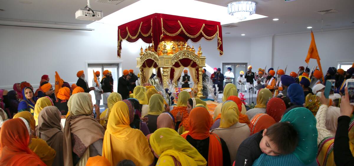 JOURNEY COMPLETE: Members of the Sikh community celebrate the opening of the city's new temple on the Kidman Way. Pictures: Anthony Stipo