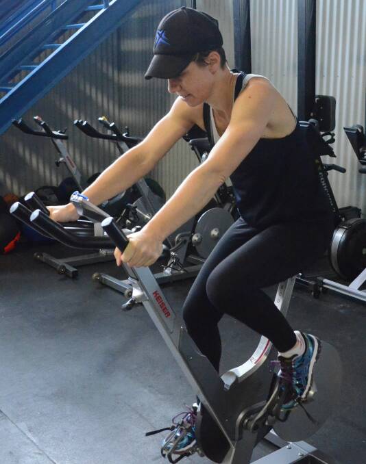 DETERMINATION: Paula Minato pushes through the pain on the exercise bike. Picture: Ben Jaffrey.