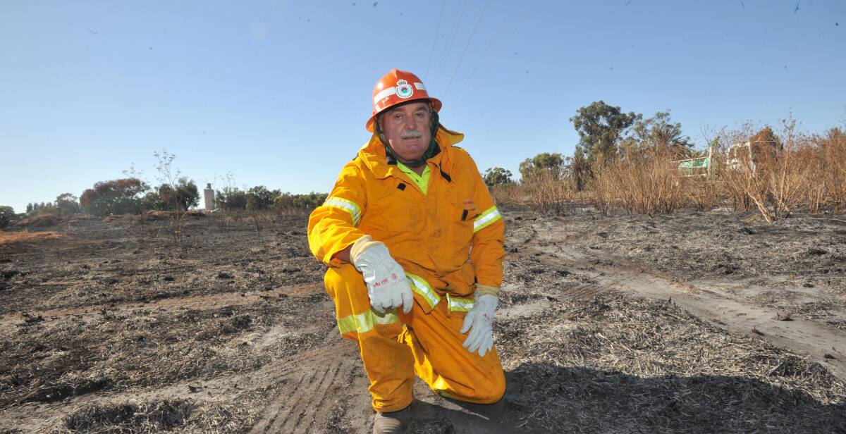 CLOSE CALL: NSW Rural Fire Service volunteer Colin Smeeth was lucky to escape unharmed in March when a power line fell on him. Picture: Anthony Stipo
