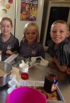 MASTERCHEFS: Year 3 students try their hand at cooking by making Anzac biscuits.