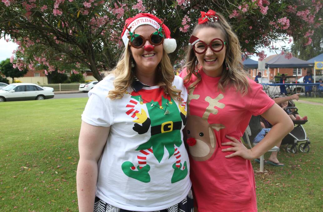CAROLS: Maddy Seach and Eloise Martyn got into the Christmas spirit and dressed for the occasion at the Yenda Carols by Candlelight on Sunday.