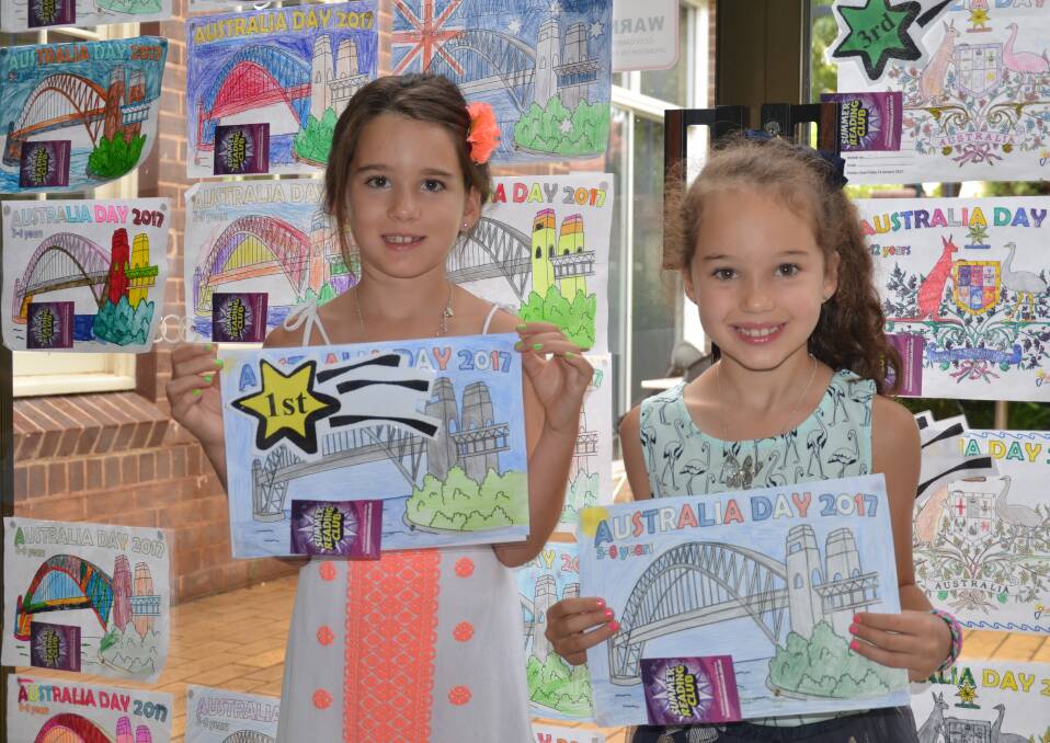 COLOUR: Isabella Ceccato and Lily Ceccato with their colourful masterpieces during Friday's early Australia Day festivities at Griffith City Library.
