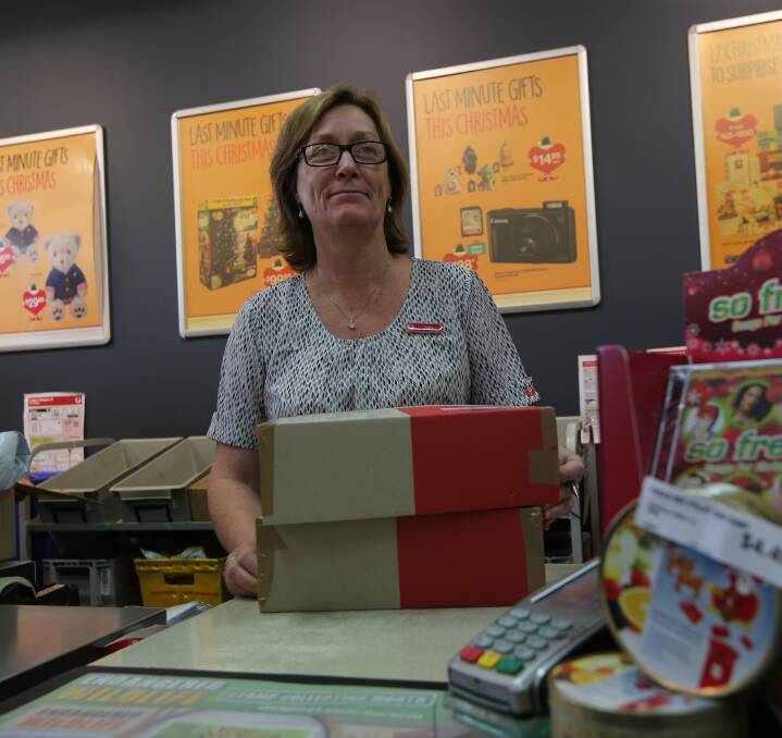 DELIVERY: Australia Post employees including Julie Croce at Griffith's post office were run off their feet during the biggest delivery day of the year on Monday. The day saw more than 2 million parcels delivered across the nation. 