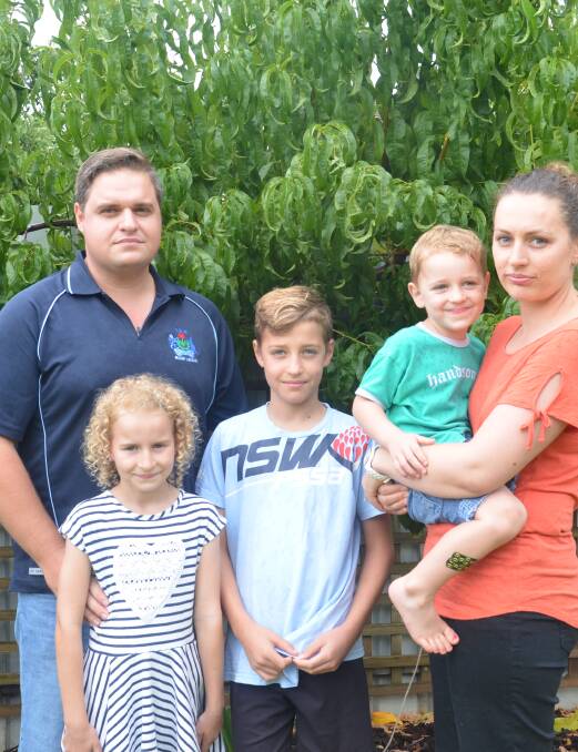 FRUITLESS: Steven Fattore with his children Mia, Jake and Josh and wife Rachael continsouly have to throw away their home-grown fruit due to fruit fly. 