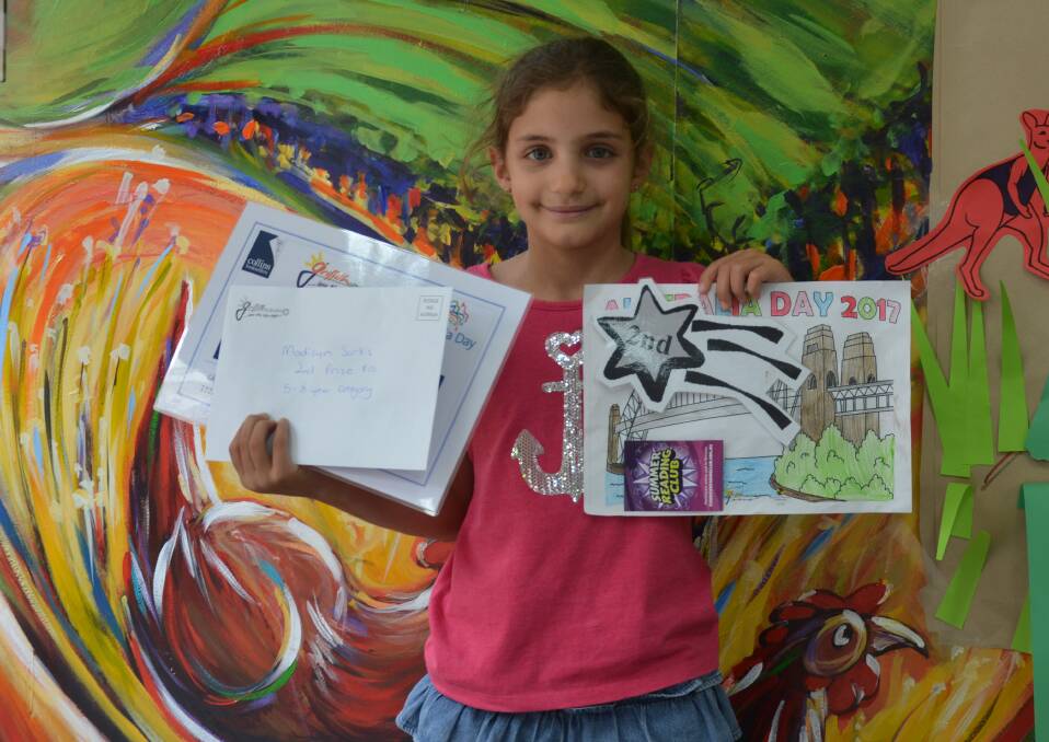 COLOUR: With picture and prizes in hand Madisyn Sarkis said Australia Day is important to celebrate all the good things about Australia and its people.