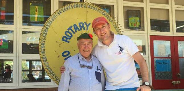 SPINNING: After spinning Rotary's chocolate wheel for more than 45 years Joe Catanzariti has passed some spinning ranks onto Alan Wedesweiler.