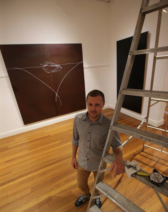 ON SHOW: Gregory Carosi hangs his upcoming show at the Griffith Regional Art Gallery, opening Saturday. PHOTO: Anthony Stipo.