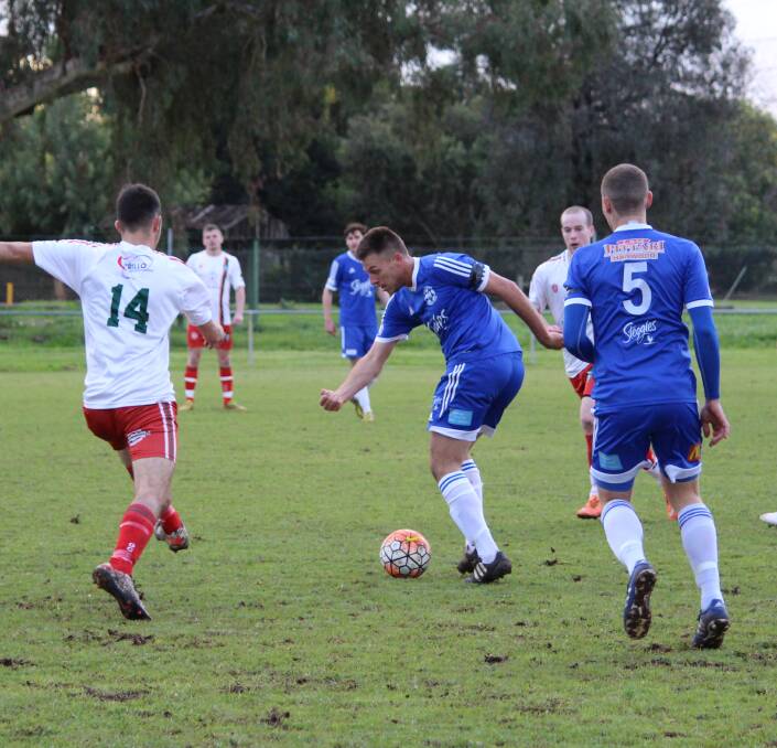 FANCY FOOTWORK: Hanwood FC's Dem Torino skillfully makes his way past Griffith City's defence. Picture: Hannah Higgins.