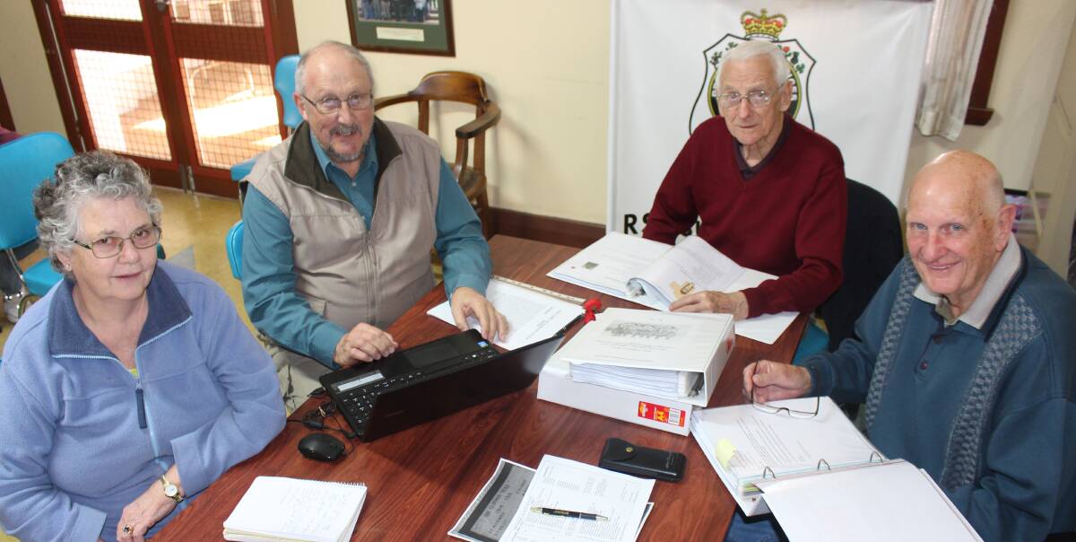 HARD AT WORK: Marg Tucker, Theo Bollen, Vince Neville and Terry Walsh hard at work in the Griffith RSL meeting rooms finding the names of men from the area who made the supreme sacrifice. Picture: Hannah Higgins.
