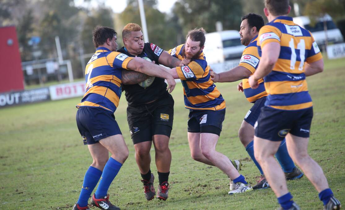 SANDWICH: Griffith's Chris Tomi pushes through despite being surrounded by Albury players. 