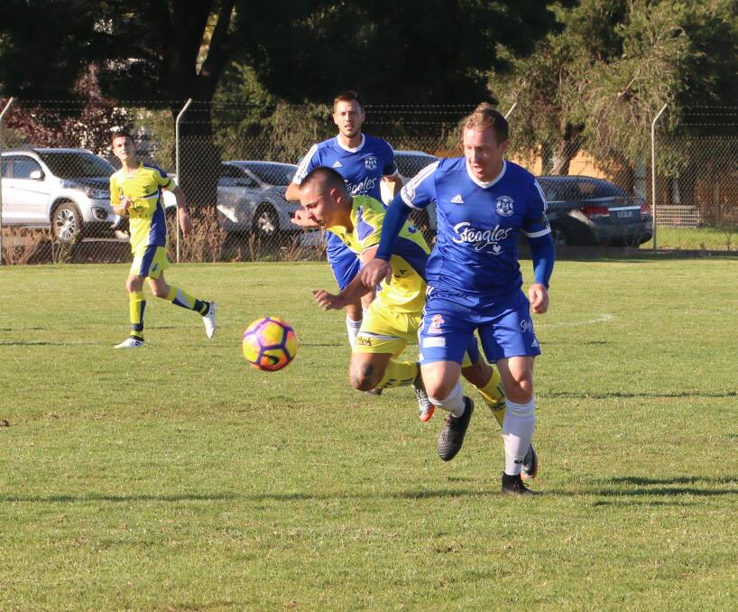 FIGHTING FOR POSSESSION: Hanwood's Bradley Clark puts in a mammoth effort in a previous match against Yoogali. PHOTO: Anthony Stipo.