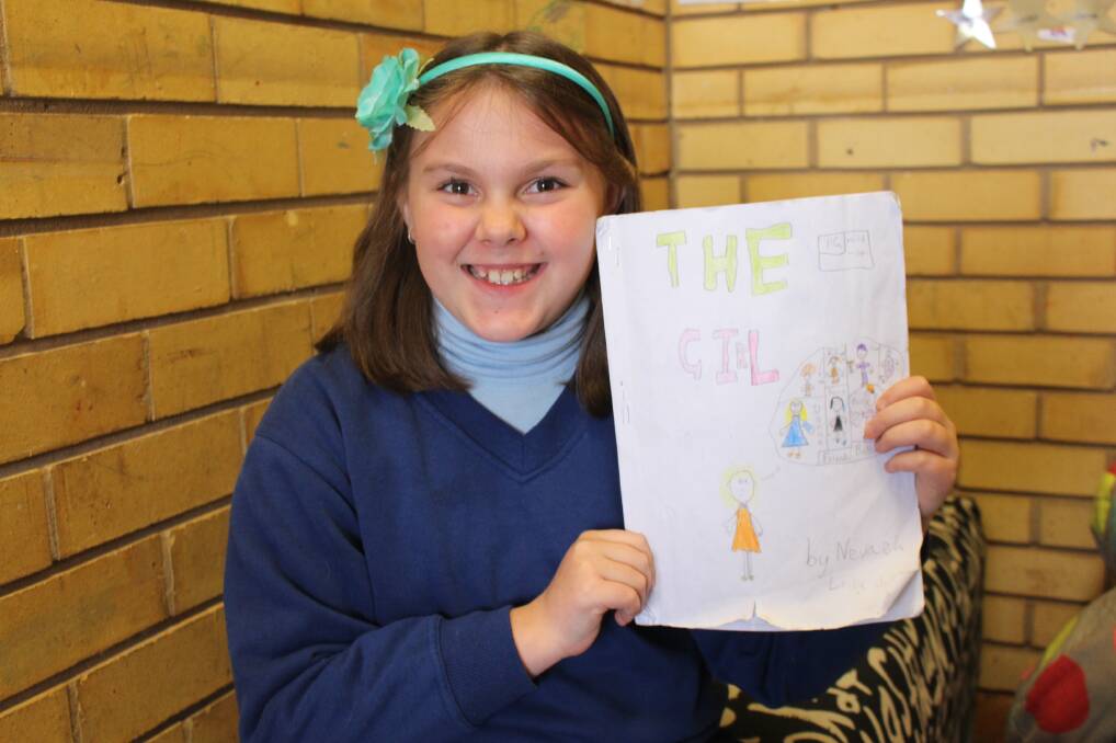 NINE-YEAR-OLD WORDSMITH: Nevaeh Eveille with her finished book The Girl, the Griffith East Student is already working on a sequel. PHOTO: Hannah Higgins.