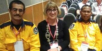 GIVING BACK: Mohammad Karim Haqjo, Sue Delves and Raymond Uda at the Australian community engagement and fire awareness conference. Picture: Supplied.