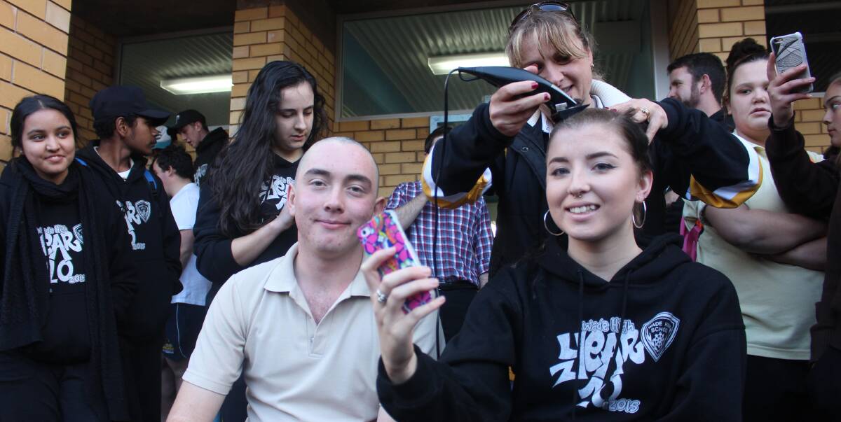 GOOD CAUSE: Darcy O’Donnell and Imogen Cooper lose their heads (of hair) at Wade High School on Friday for the World's Greatest Shave. Picture: Hannah Higgins.