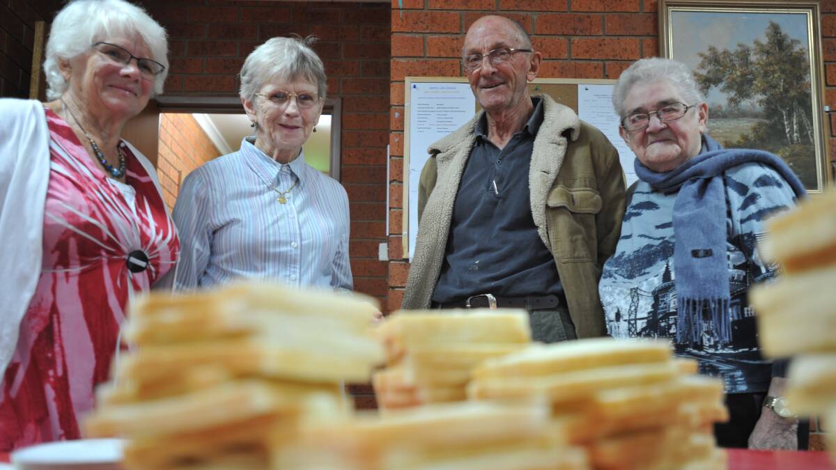 THANK YOU: Lucy Binello, Cecily Agnew, Angelo Maloni and Peg Jones stand behind the mountains of bread they had readied for their sausage sizzle.