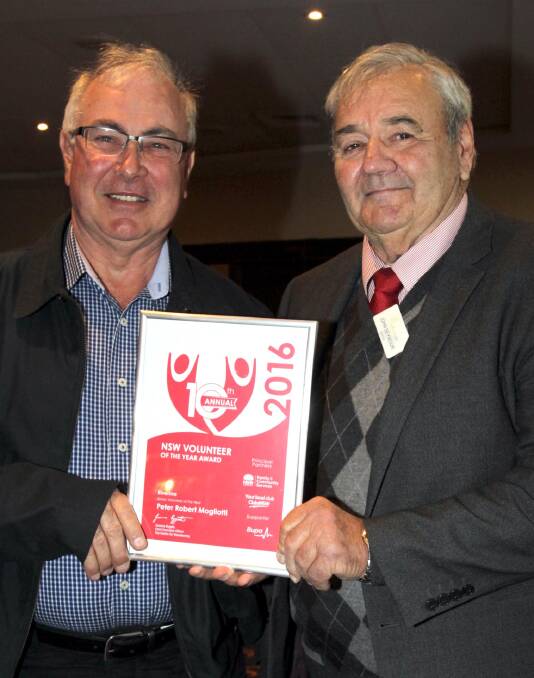 Robert Mogliotti, left, receives Volunteer of the Year Awards from Coolamon Shire mayor John Seymour.