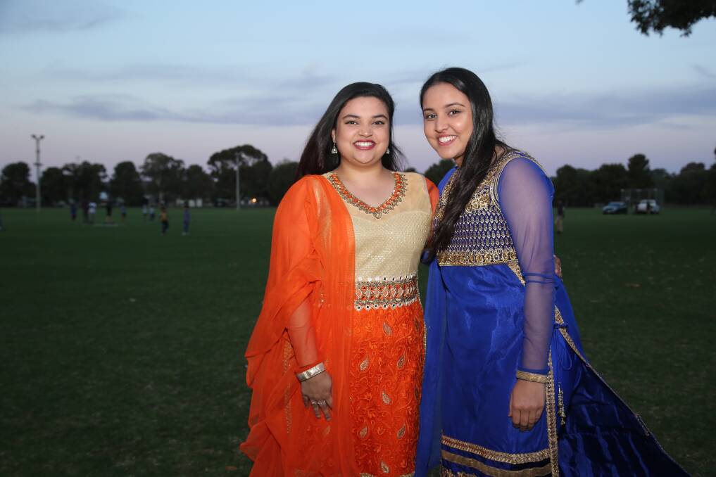 SISTERLY LOVE: All dressed up for the festivities, Sunalica Kumar and Shivagani Kumar were enjoying an evening filled with prayer, food and of course the much-anticipated fireworks. PHOTO: Anthony Stipo.