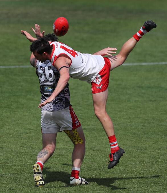 UP IN THE AIR: Swans' player Andrew Cappello, and Mitch Pilon for Collingullie Glenfield Park at the RFL reserve grade Grand Final game at Narrandera on the weekend. PHOTO: Les Smith.