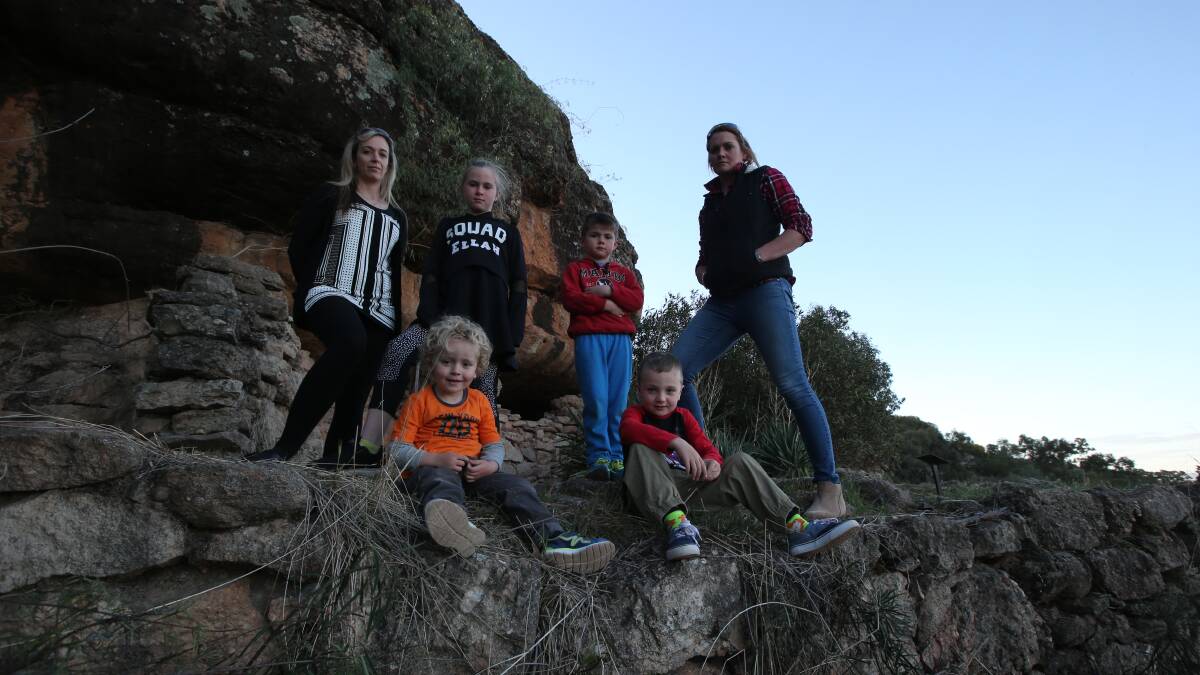 DISGRACEFUL: "We need these places for our kids to go and enjoy," Ms Anderson said. Back: Kathy Anderson, Ellah Aventi 8, Zac Aventi 5, Cass Mitchell. Front: Tyler Thacker 3 and Nate Thacker 6 at Hermit's cave. PHOTO: Anthony Stipo.