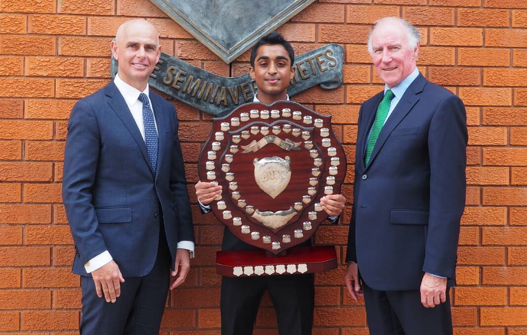 DEREK Komban holds the Dux Shield, with assembly guest speaker, Member for Camden Chris Patterson (left) and St Gregory's headmaster Damian Millar.