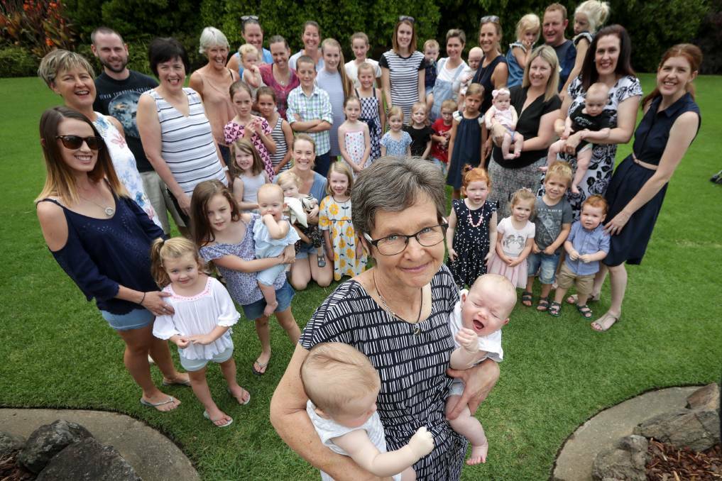 Jenny Ellis, with just a handful of the children she has delivered as a midwife, has received an Order of Australia Medal. Picture: JAMES WILTSHIRE

