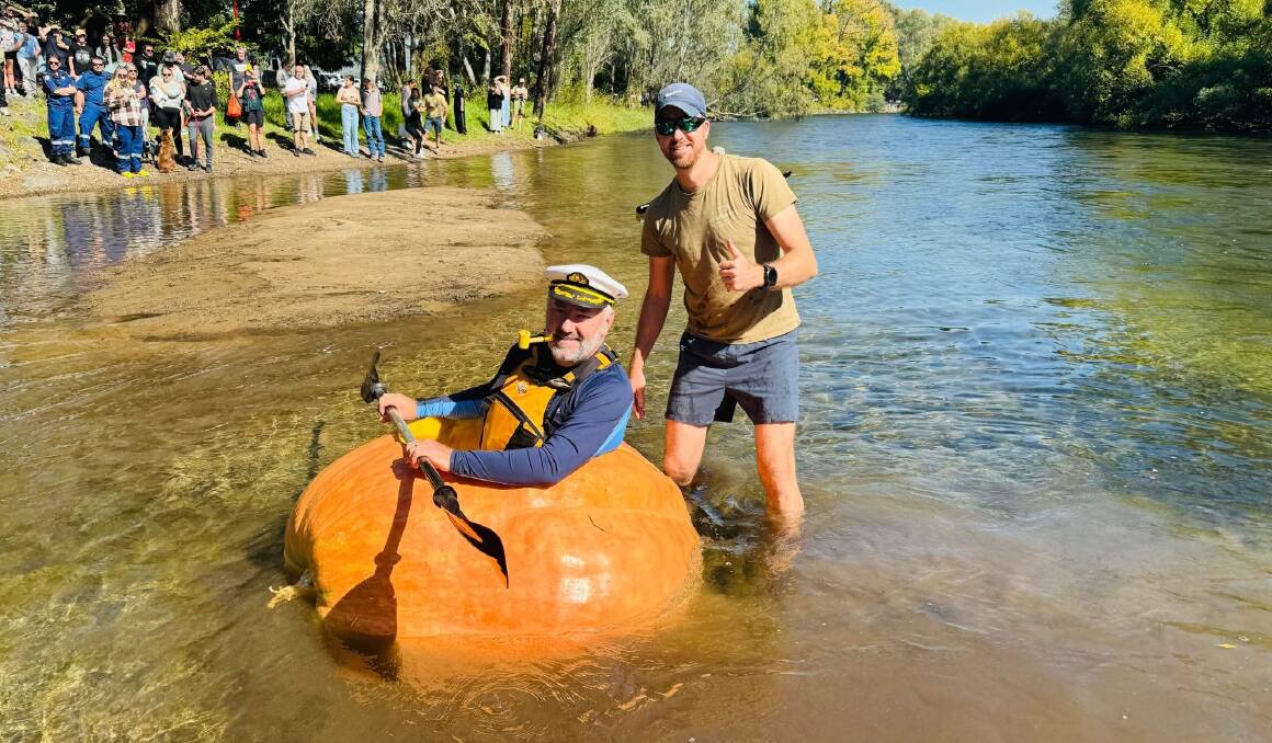 In an 'oh my gourd' kind of moment, Captain Adam Farquharson takes to the Tumut River in his boat - a giant pumpkin grown by Tumut's Mark Peacock - on Saturday. Picture supplied 