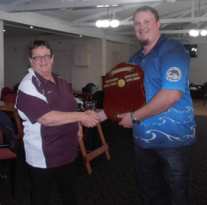 CLOSE ENCOUNTER: Griffith player Daphne Mott presents the shield to Yarrawonga's Mark Hopgood. Picture: Supplied
