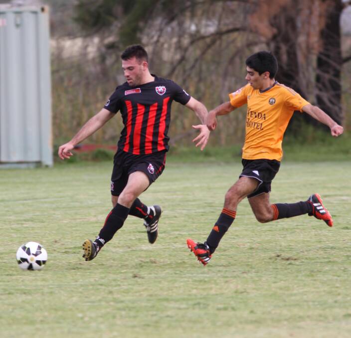 SAFE: Leeton's Joey Fondacaro looks to boot the ball clear of Yenda's Eduardo Clebsch Garcia in their Billabong Cup clash last week. Picture: Briana Bryon