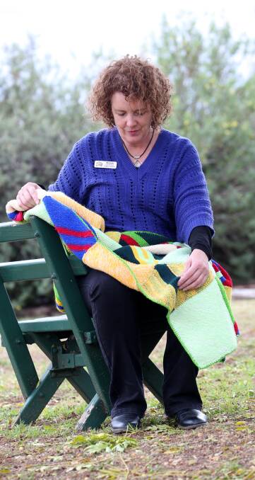 GIVING: Michelle Bordignon admires one of the blankets that she has received from generous donors. Picture: Anthony Stipo.