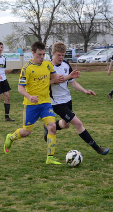 SHOVE: Yoogali FC's Ben Watts (left) and Wests' Gavin Wylie shoulder each other for possession. Picture: Ben Jaffrey