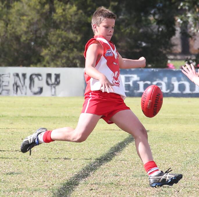 LONG BALL: Griffith Swan Oliver Bartter bombs a kick towards the forward line. Picture: Anthony Stipo