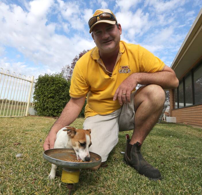 IDEAS MAN: XXXX Ambassador Lindsay Flack shows off his latest invention, the ant-proof dog dish. Picture: Anthony Stipo.