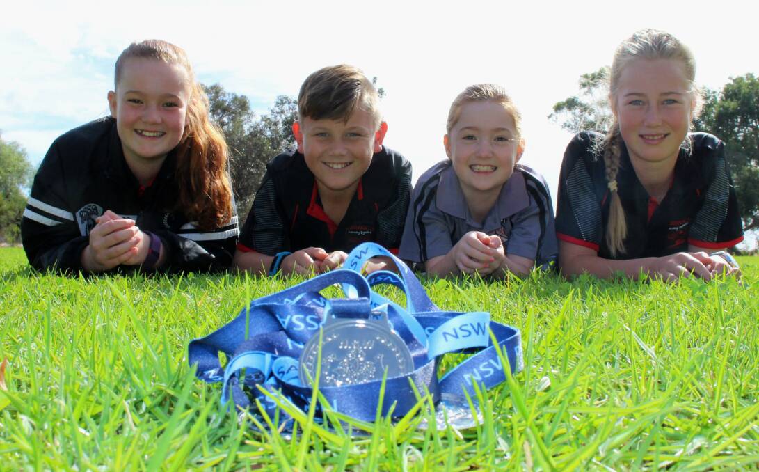 SPEEDY SWIMMERS: Amelia Burcham, 12, Harry Rowston, 11, Claire Burcham, 9, and Leah Boyd, 12. Picture: Ben Jaffrey