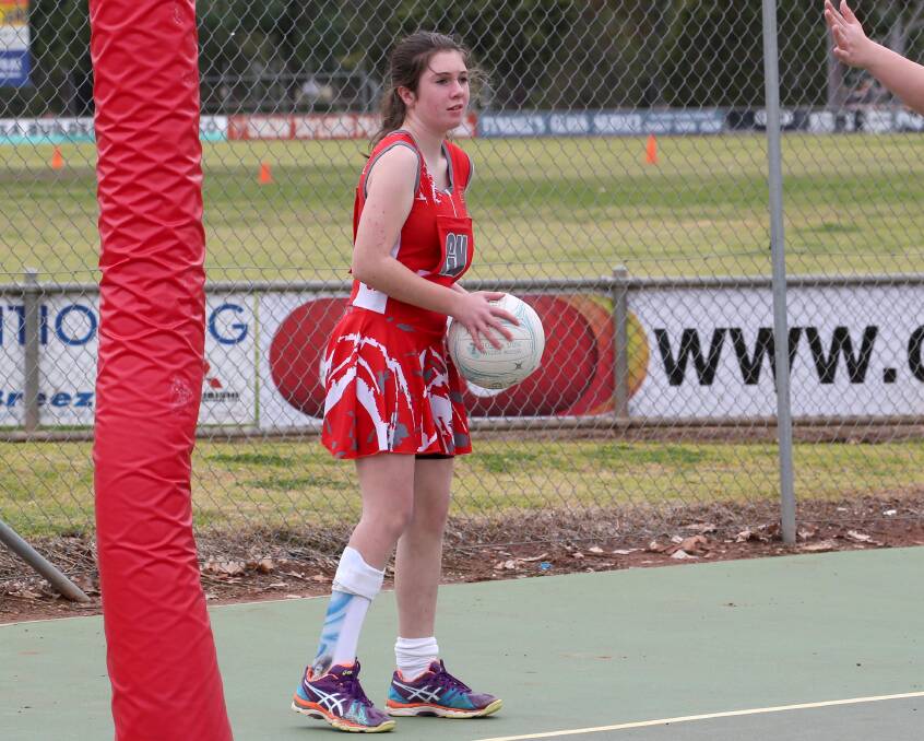 PASS: Under 15s player Maggie Fry looks for a Swans team-mate to pass to. Picture: Anthony Stipo.