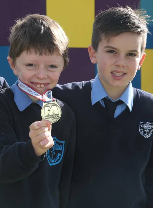 GOING THE DISTANCE: Callum De Bortoli, 10, proudly displays his gold medal alongside fellow St Mary's Primary School student Jordan Piva, 11. Picture: Anthony Stipo