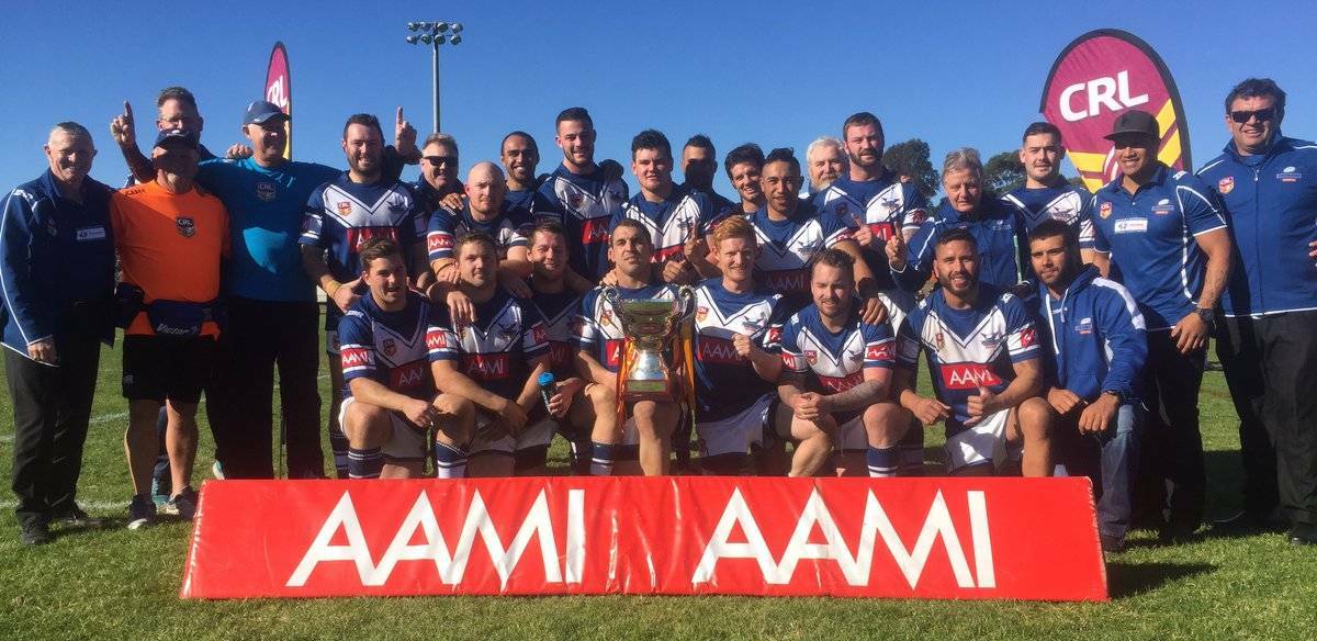 CHAMPIONS: Josh Charles, pictured holding the trophy, and his Newcastle teammates celebrate after beating Illawarra 23-12 in the final of the NSW Country Championships in Camden on Saturday.