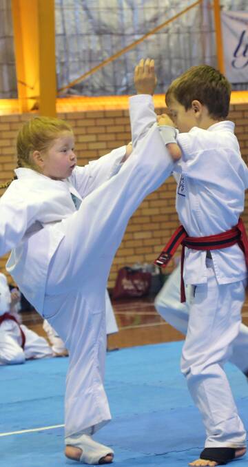 BLOCK: Shakiya Murray and Ethan Martin compete in the non-contact boys and girls' karate at Westend Stadium. Picture: Anthony Stipo