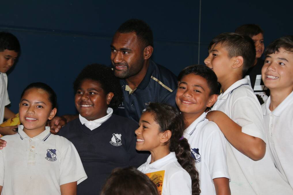 KING OF THE KIDS: Tevita Kuridrani gets a photo with students from Griffith Public School on Tuesday. PHOTO: Anthony Stipo