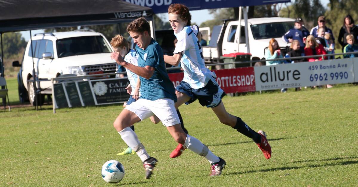 PACE: Riverina Rhino Benjamin Smith looks for some room as a Sutherland defender closes in. Picture: Anthony Stipo