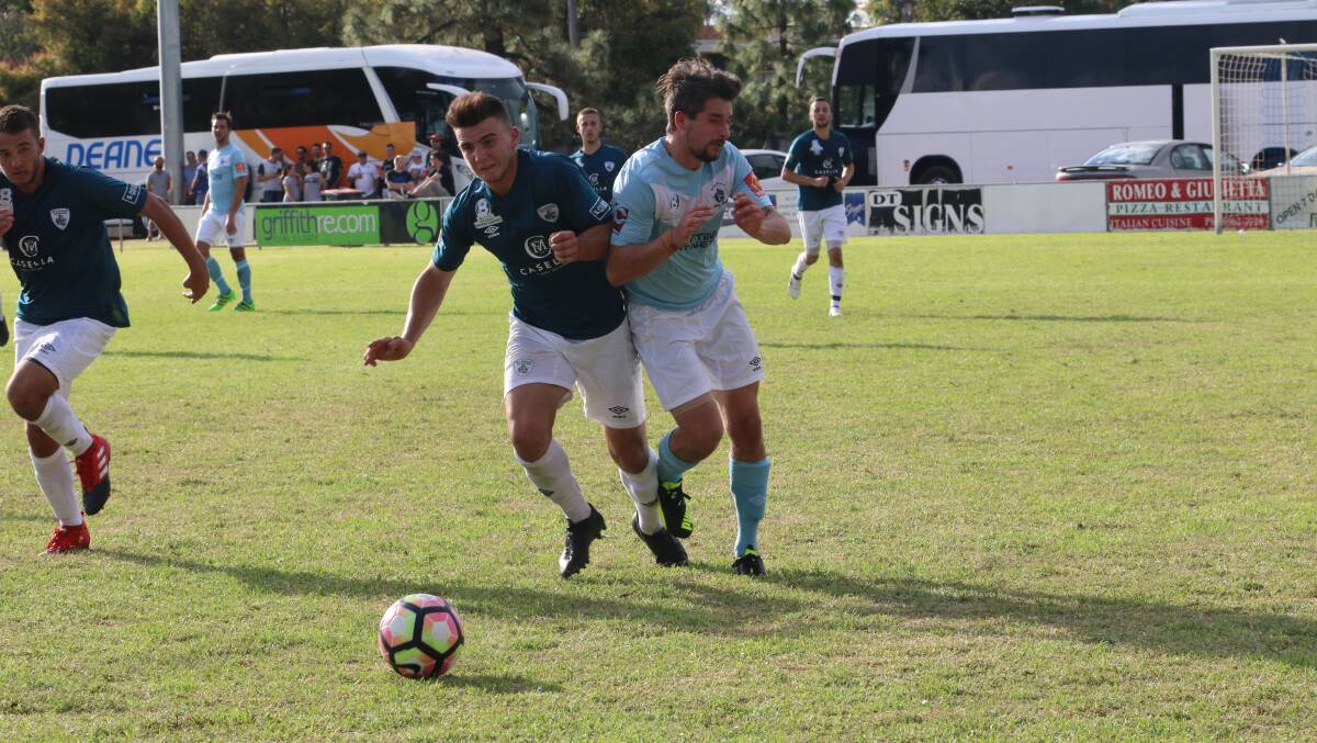HUNGRY: Riverina Rhino Jacob Donadel clashes with a Belconnen United player earlier this year. PHOTO: Anthony Stipo