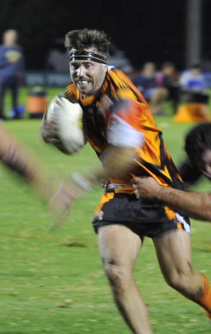 CLOSE: Waratah Chris Hanneman takes a charge at Yanco-Wamoon's line in the second half. Pictures: Ben Jaffrey