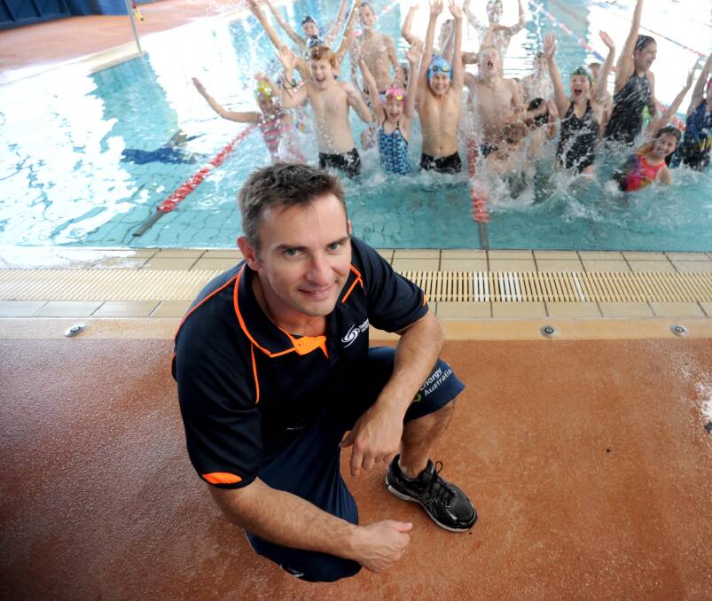 MAKING A SPLASH: Alex Hirschauer takes a break from training with Griffith Swimming Club members. Picture: Anthony Stipo