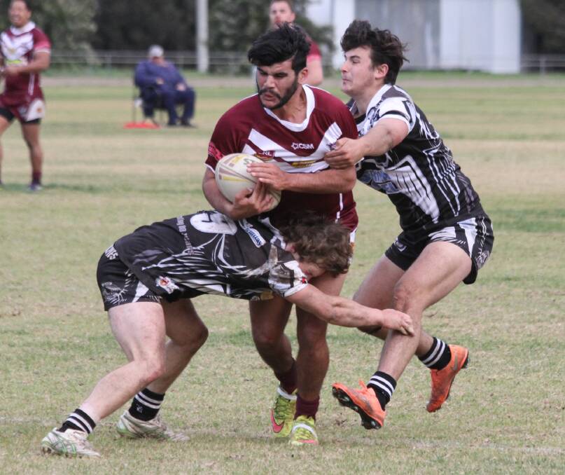 IMPACT: Yanco-Wamoon's Billy Ingram is tackled by a pair of Hay defenders last week. Picture: Ron Arel