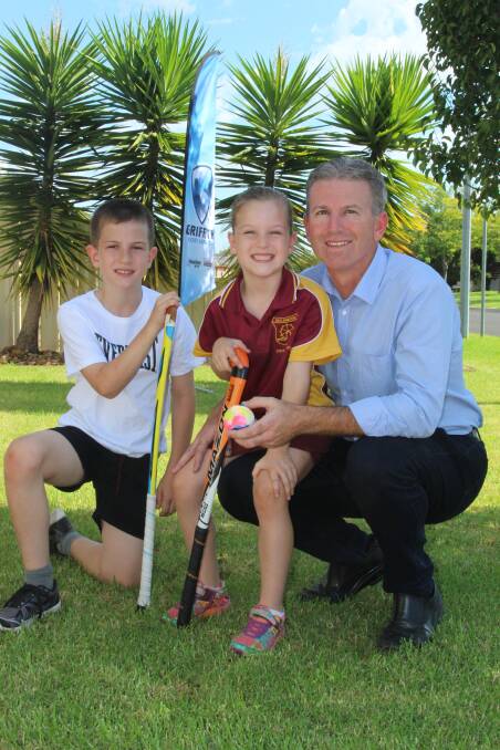 COME AND GIVE IT A GO: Griffith Hockey Association junior development officer Andrew Sinclair with his children, Ben, 9, and Ella, 6. PHOTO: Anthony Stipo