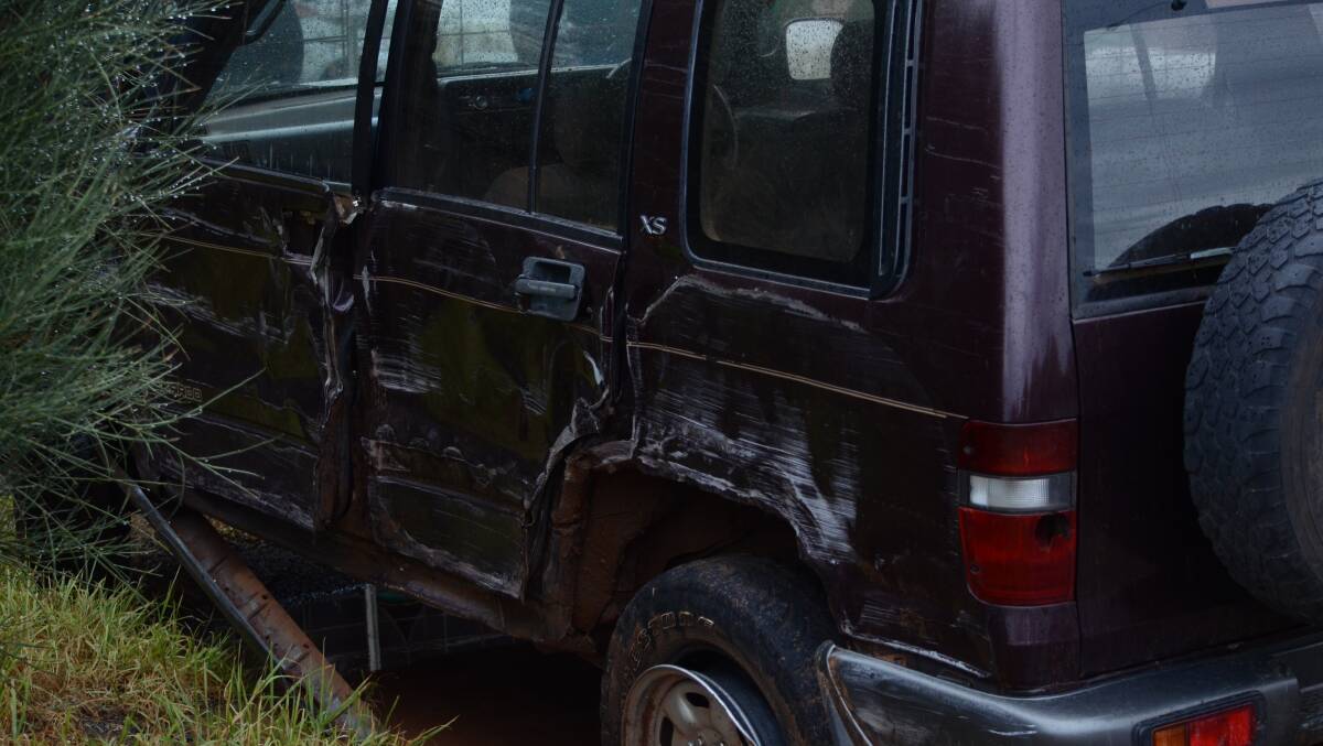 SIDE-SWIPED: The Holden Jackaroo after it was hit by the truck.
