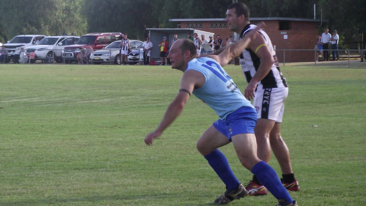 NEW CHALLENGE: Barellan backman Jeff Mickan on TRYC's Andy Carey in the club's first game back in the Farrer League. Mickan has taken on the president's job.