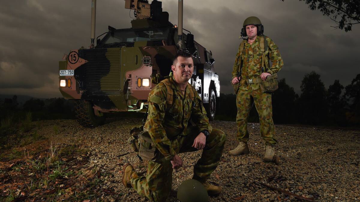 VITAL SERVICE: Australian Army soldiers Corporal Ian Wilson and Warrant Officer Class 2 Cameron McKenzie with the Army Logistic Training Centre's "bushmaster" tank at Bandiana. Picture: MARK JESSER